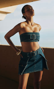 Image of woman in denim top and skirt set.