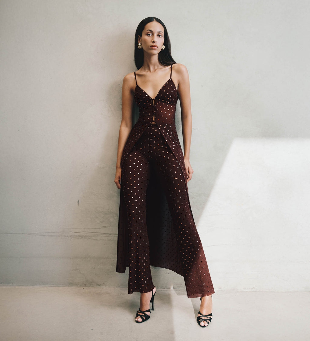 Woman wearing a brown set with embellishments.