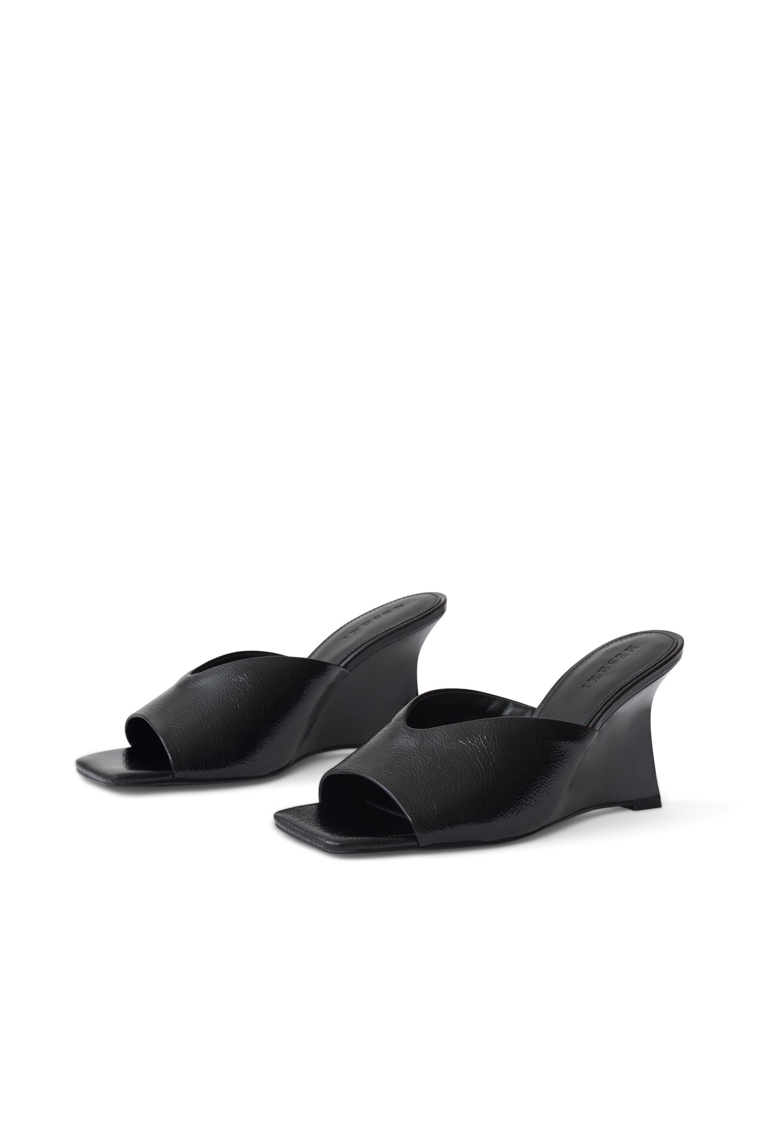 A pair of black leather wedge mule sandals with a square toe, displayed on a clean white background.