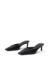 A pair of black pointed-toe mule heels with slim kitten heels, shown from a three-quarters angle on a clean white background.