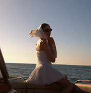Image of woman in white mini dress.