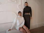 Image of women in grey knit dress and charcoal knit sweater and skirt.