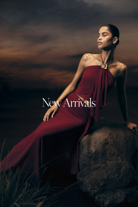 Woman in a red set sitting on a rock with 'New Arrivals' text overlay.