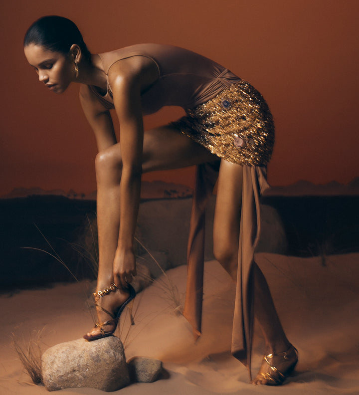 Woman in embellished outfit.