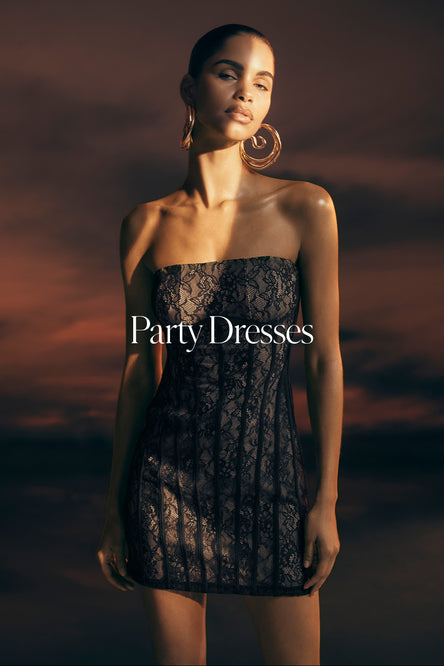 Woman wearing a black lace dress with 'Party Dresses' text against a dark background.