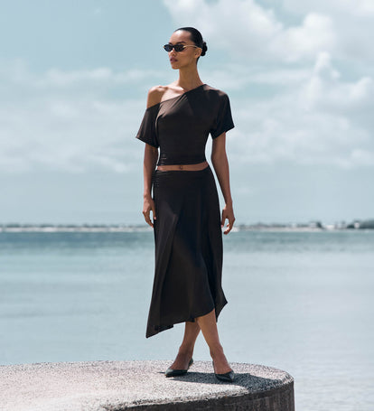 Image of woman in brown matching top and skirt set