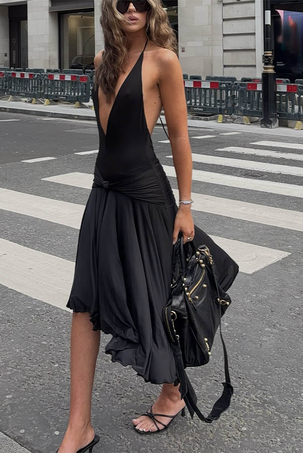 Woman in black plunge midi dress