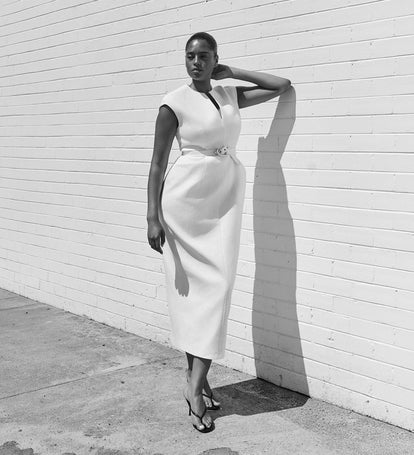 Image of woman in white belted midi dress