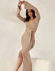 Image of woman wearing matching beige wrap knit set