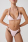 A model wearing a two-tone bikini set with a light pink and dark brown color combination, photographed against a neutral light gray background.