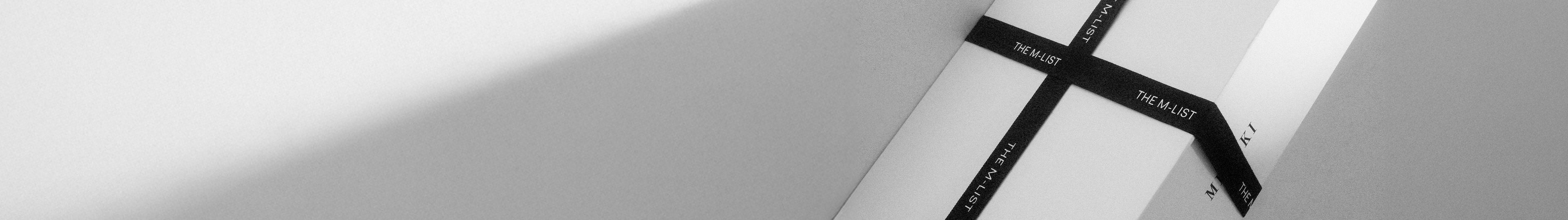 White box with black 'THE M-LIST' tape.