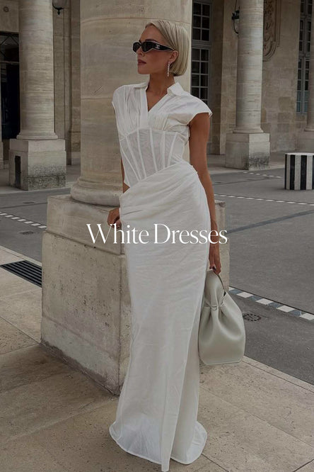 Woman in a white dress standing in front of classical architecture with 'White Dresses' text overlay.